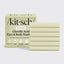 Kitsch glycolic acid face and body wash packaging with bars of soap on a light gray background