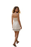 Woman in a white dress standing on a stone path with people in the background
