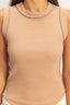 Beige sleeveless top worn by a person against a neutral background
