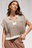 Woman wearing a striped sleeveless top against a neutral background