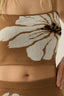 Brown garment with floral pattern worn by a person