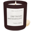 Candle with a label reading 'Driftwood and Mahogany' by Sweet Water Decor on a white background.