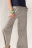 Person wearing striped pants with a plain background