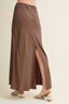Brown maxi skirt with a slit on a neutral background