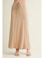 Beige skirt worn by a person on a plain background