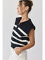 Woman wearing a black and white striped top against a plain background