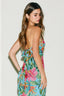 Woman wearing a colorful floral dress against a white background