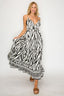 Woman wearing a black and white patterned dress on a white background