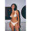 Woman wearing a white bikini with black stripes in an indoor setting.
