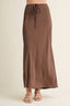 Brown skirt worn by a person on a beige background