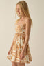Woman wearing a floral dress against a plain background