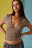 Woman wearing a leopard print top against a multicolored background