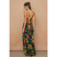 Woman wearing a colorful floral dress against a beige background