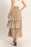 Beige tiered skirt worn by a person on a plain background