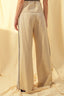 Beige pants with a subtle pattern on a beige background