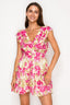 Woman wearing a pink floral dress on a white background