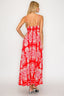 Woman wearing a red floral dress on a white background