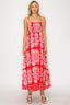 Woman wearing a red floral dress on a white background