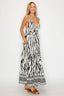Woman wearing a black and white zebra print dress on a white background